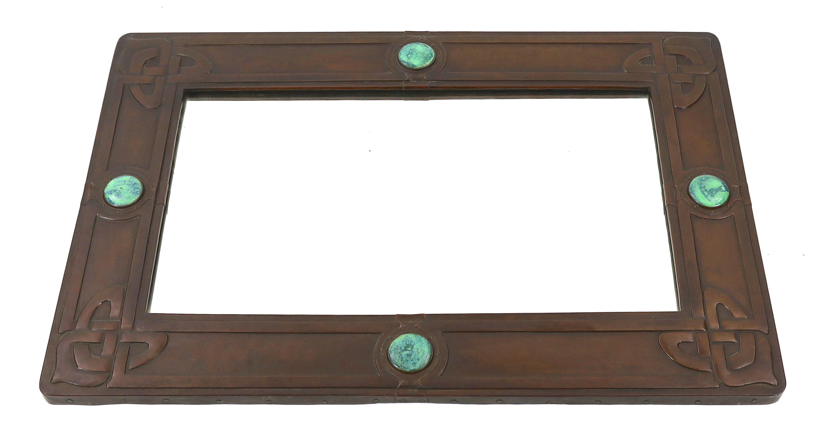 A Liberty Arts & Crafts embossed copper and 'Ruskin stone' wall mirror, designed by Archibald Knox, 91.5cm wide, 61cm high